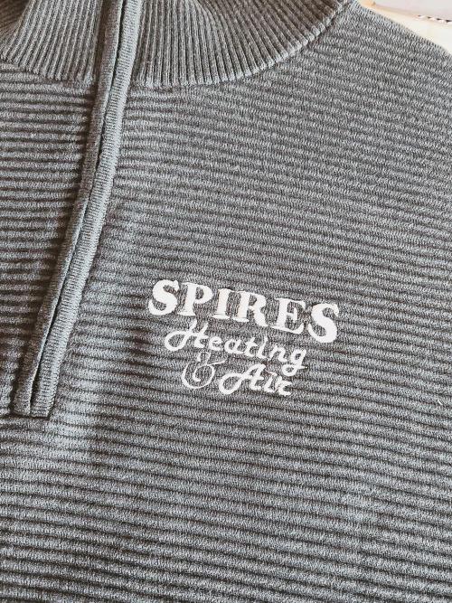 "SPIRES Heating & Air" business logo embroidered on the chest of a heather gray quarter-zip pullover