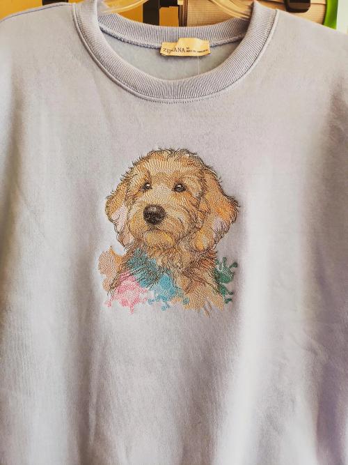 Lavender pullover sweatshirt with a detailed photo-realistic embroidered portrait of a golden doodle puppy and a watercolor-style paint splash accent