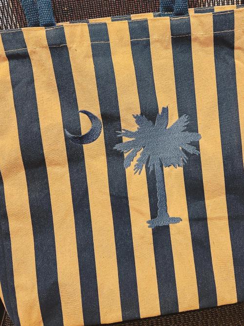 Navy and gold striped canvas tote bag embroidered with a navy South Carolina palmetto tree and crescent moon