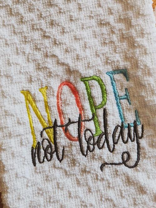White terrycloth hand towel embroidered with the playful multicolor phrase "NOPE not today"