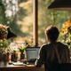 Person working thoughtfully at an organized desk with laptop displaying helpful AI interface elements, surrounded by natural lighting, plants, and personal touches in a comfortable workspace