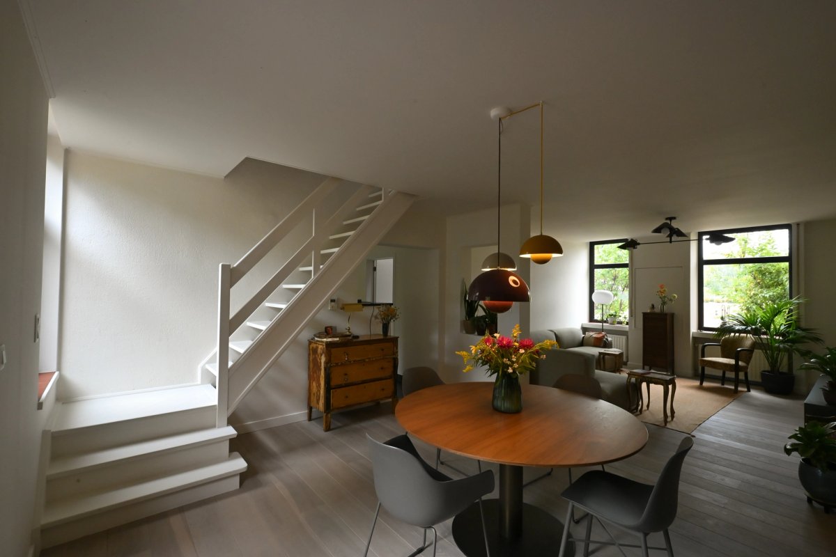 Dining room and living room with stairs leading to the upper floor