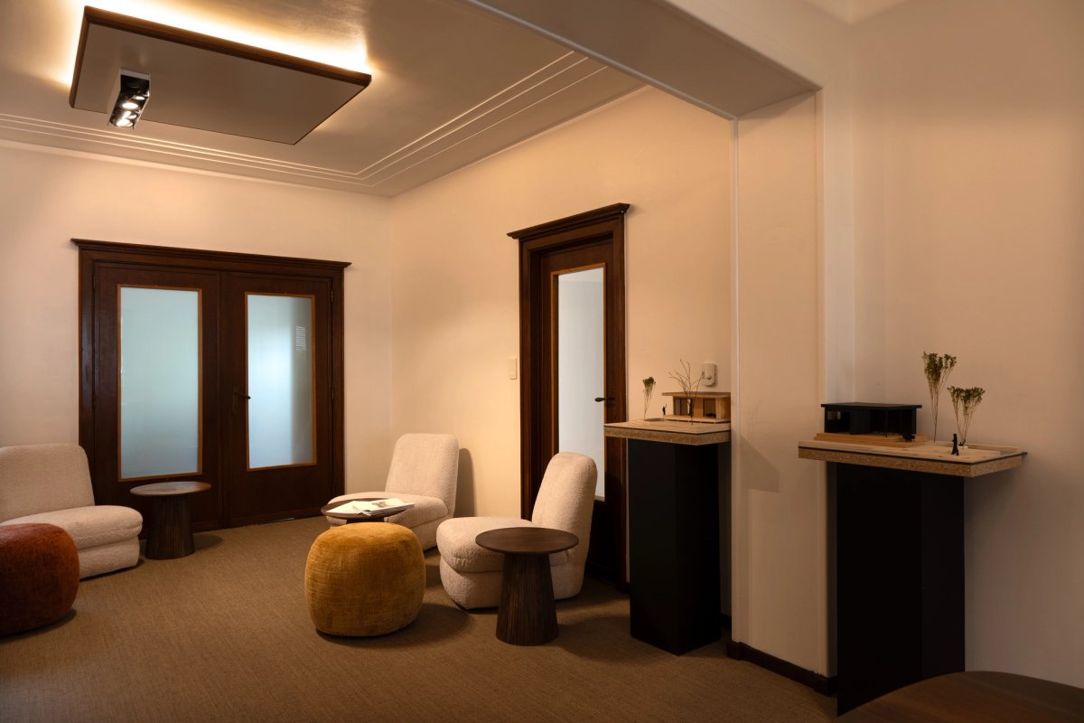 A warm and inviting sitting room designed for relaxation, with comfortable furniture, soft lighting, and a cosy atmosphere