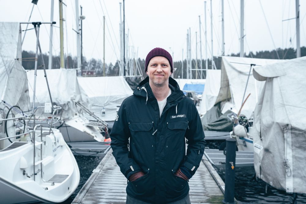 Man standing outside in front of boats