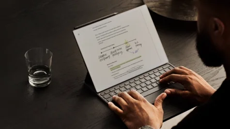 Man sitting a writing on a Type Folio