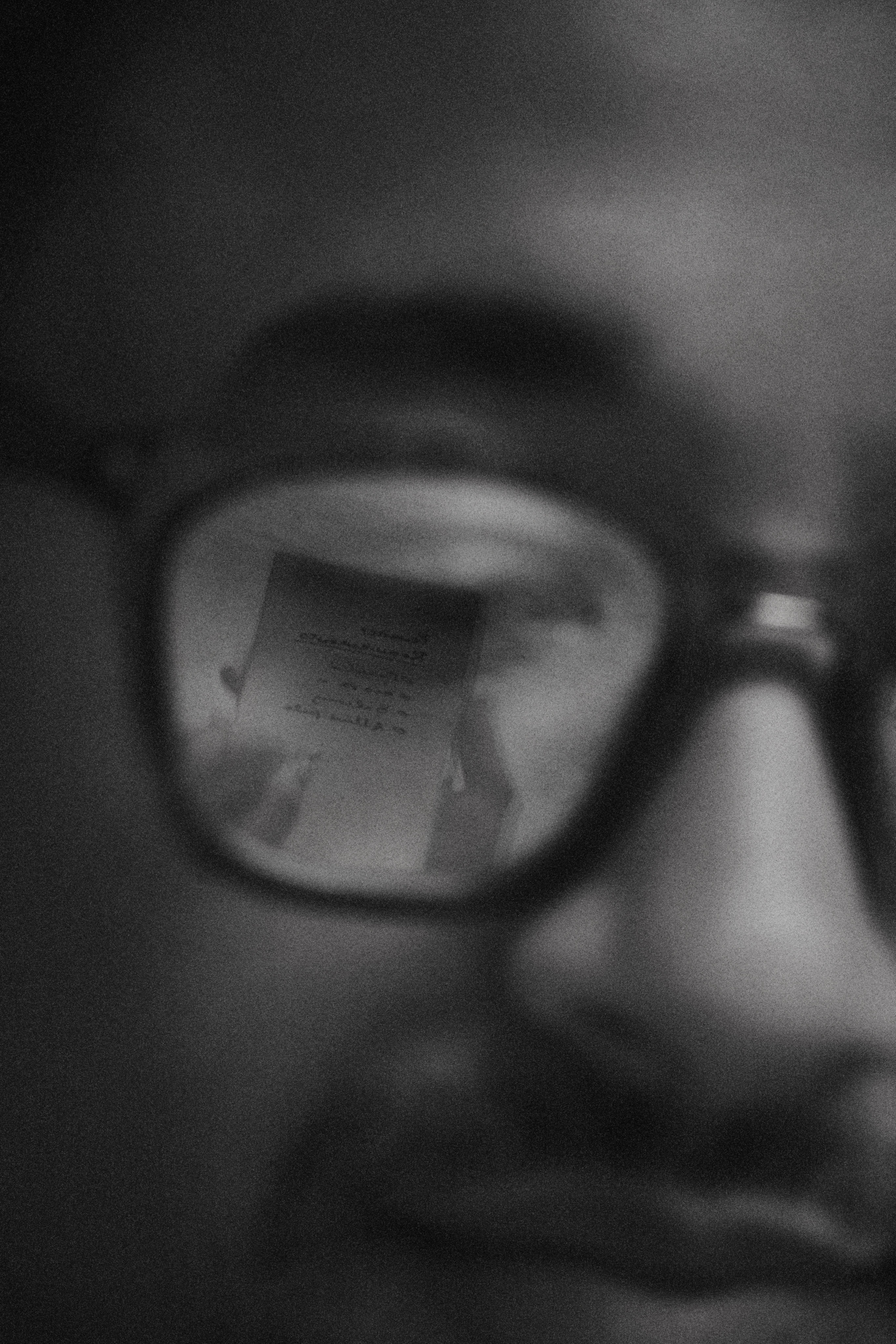 Close-up reflection of a document in glasses. reMarkable paper tablet not visible.
