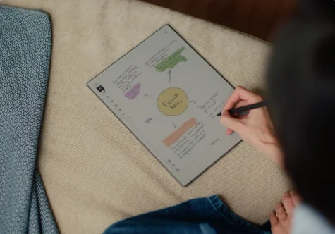 A person writing on a reMarkable paper tablet with the Marker.