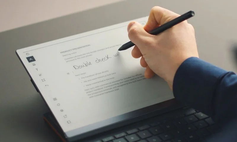 reMarkable paper tablet: a person writing a note with the Marker Plus on the device with Type Folio.