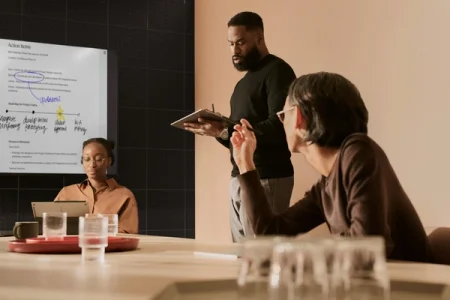 A man presenting to his team in a meeting room