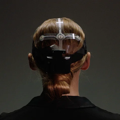 A woman wearing a brain-computer interface device.
