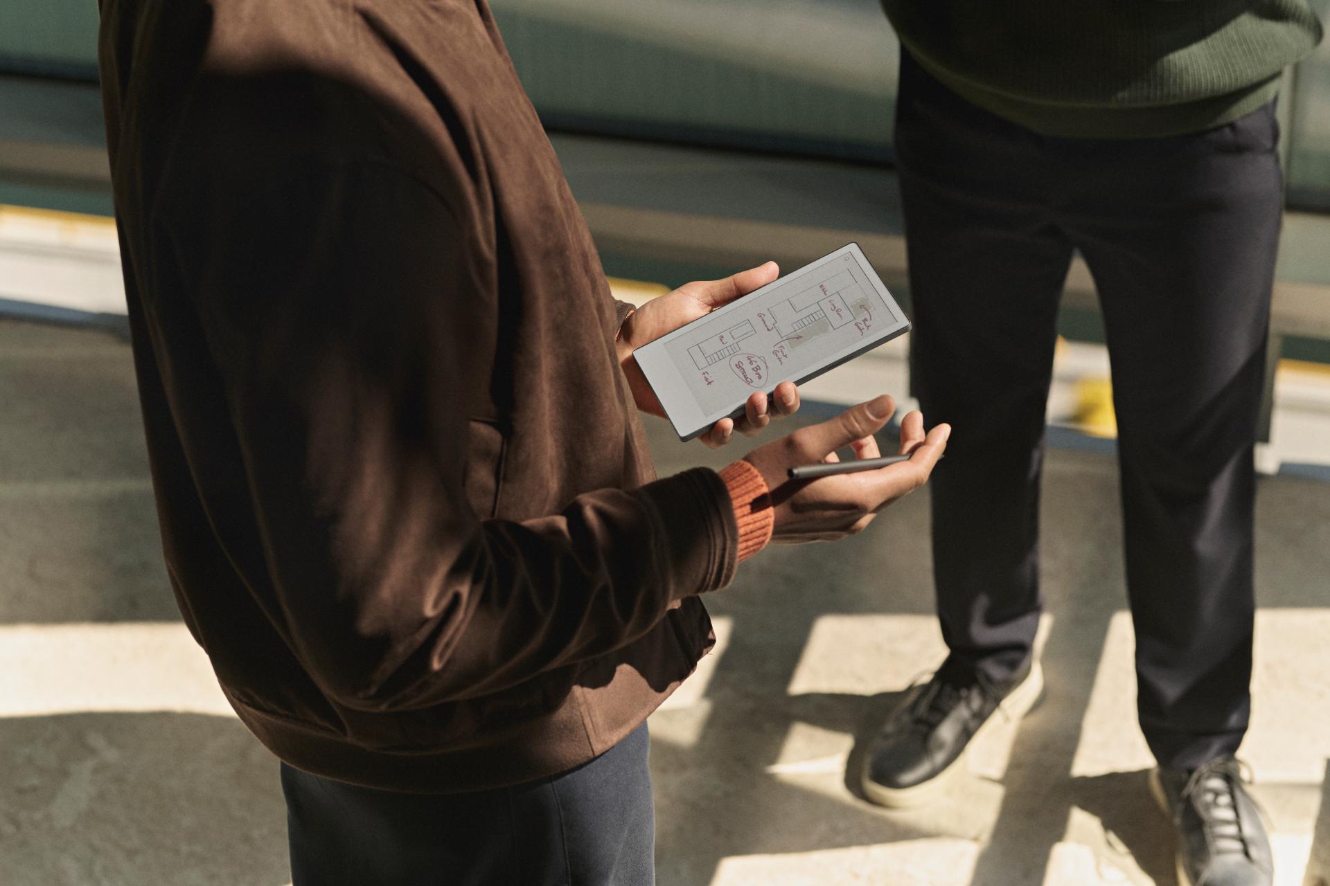 People in business attire stand near steps.