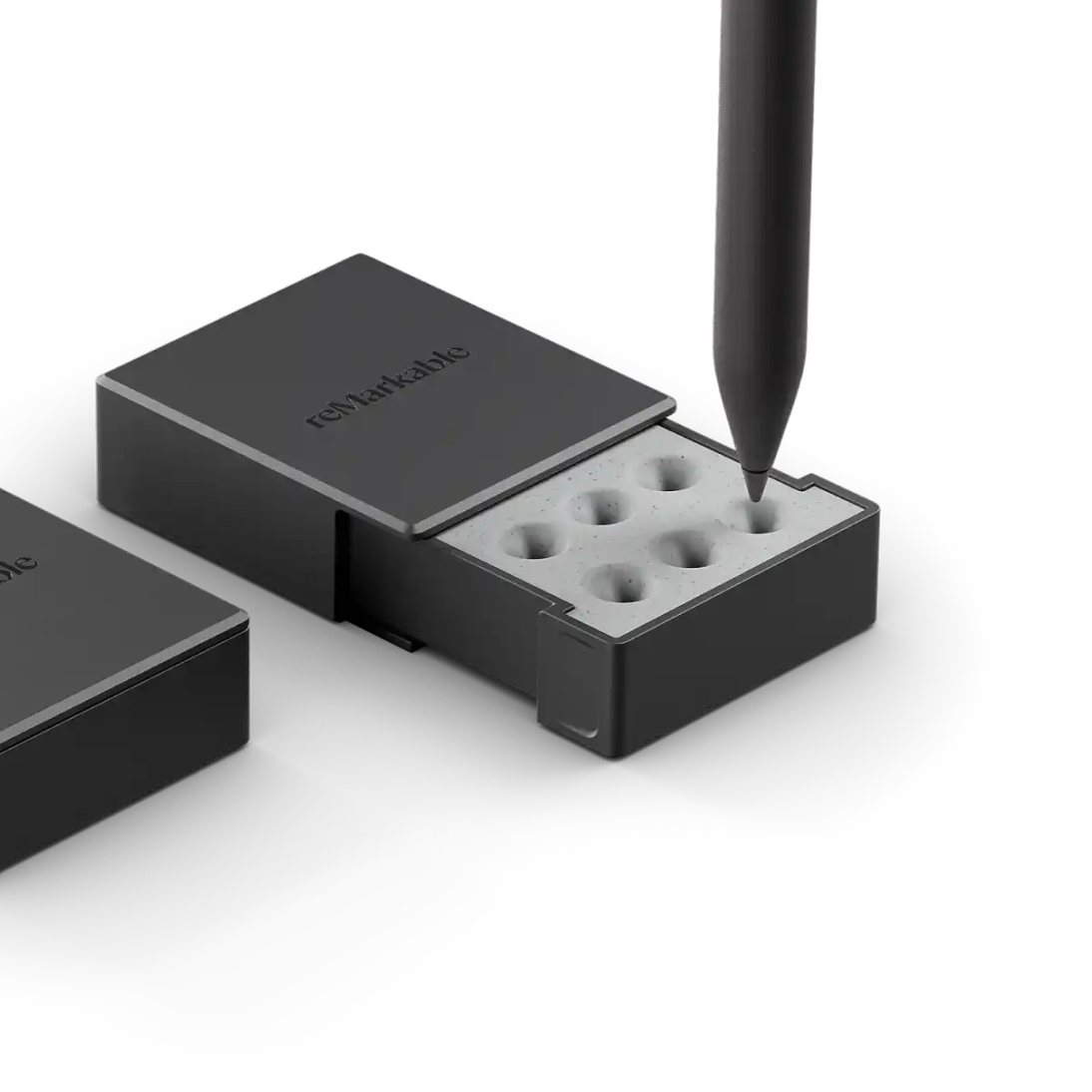 reMarkable Marker tips in a storage case, with a Marker hovering above.
