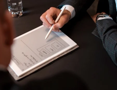 A reMarkable paper tablet with a Marker drawing a flowchart diagram in a business meeting.