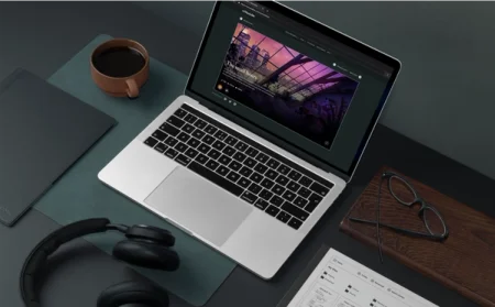 reMarkable paper tablet next to headphones and coffee on desk. Laptop on with "The small hours" visible on screen.