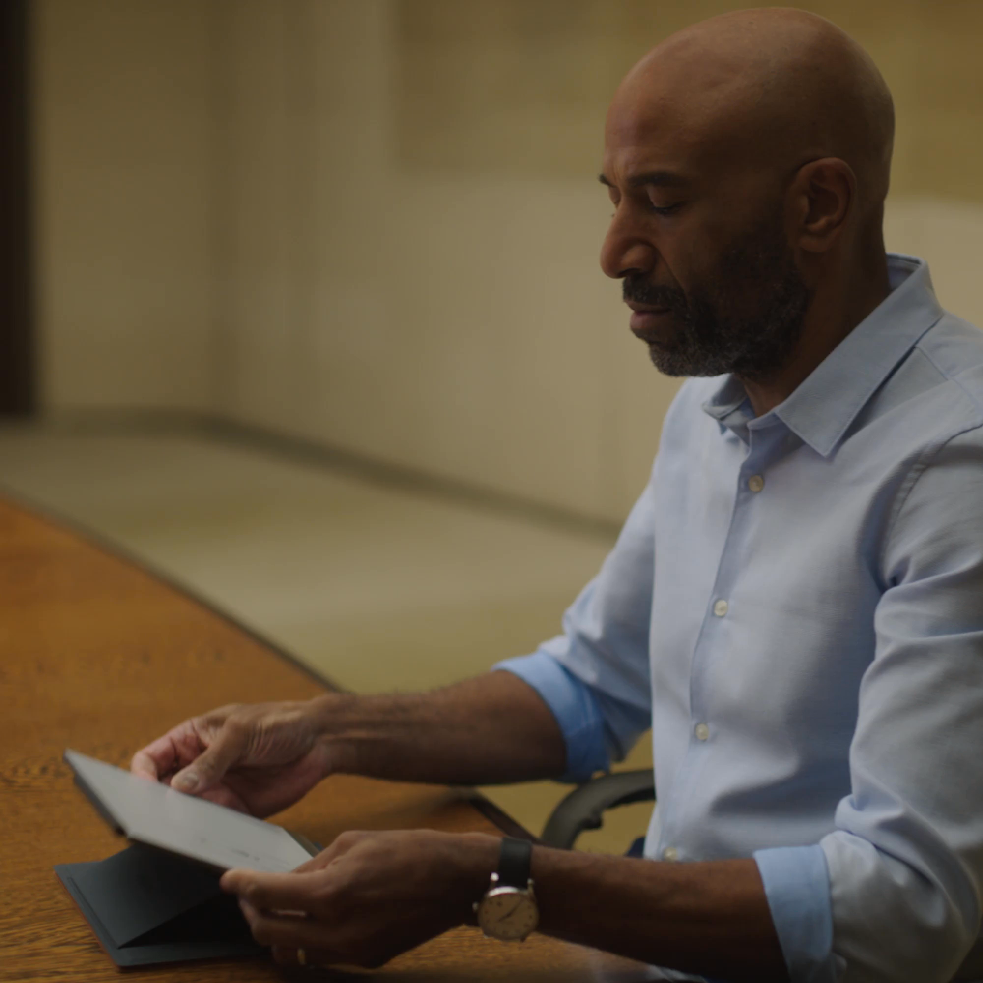 Person unfolding the Type Folio on a reMarkable paper tablet sitting at a desk.