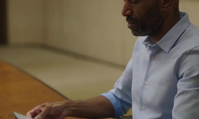Person unfolding the Type Folio on a reMarkable paper tablet sitting at a desk.