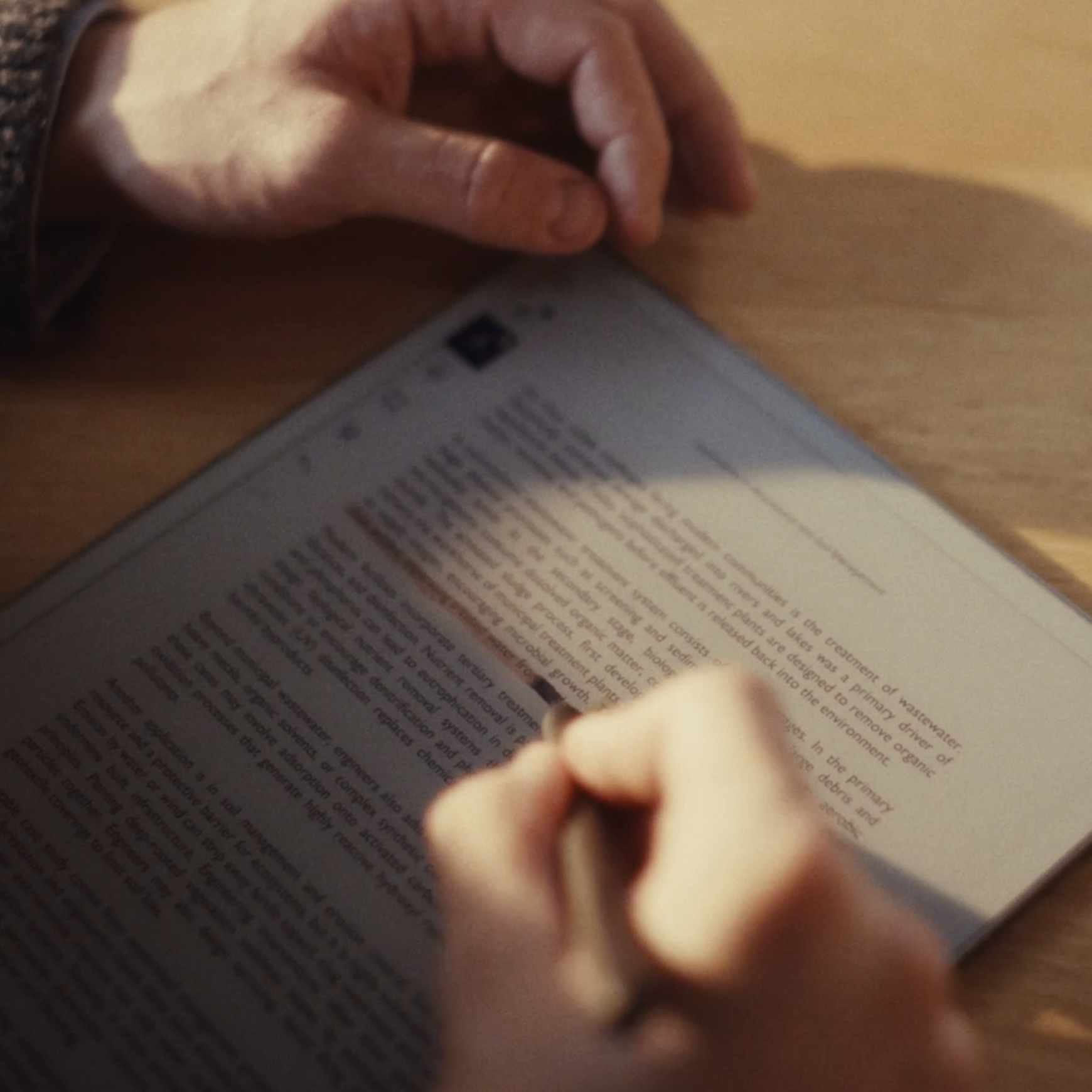 A close-up of a student reviewing a PDF document on the reMarkable Paper Pro, highlighting a sentence with the Marker Plus.