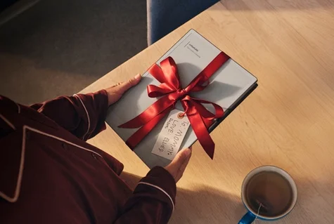 A reMarkable paper tablet wrapped as a gift with a red ribbon.