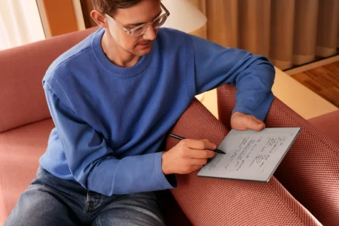 A man writing on the reMarkable device.