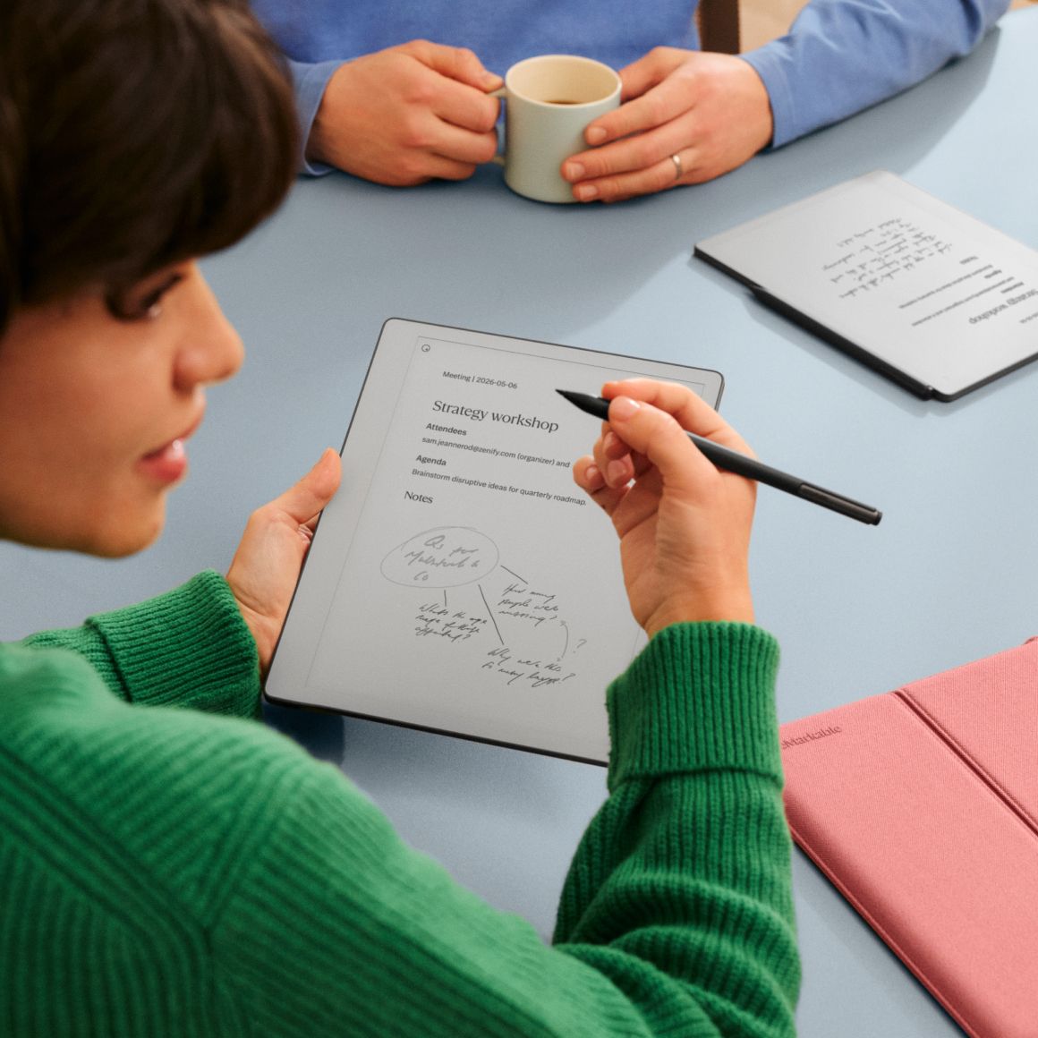 A woman taking notes on reMarkable Paper Pure in a meeting
