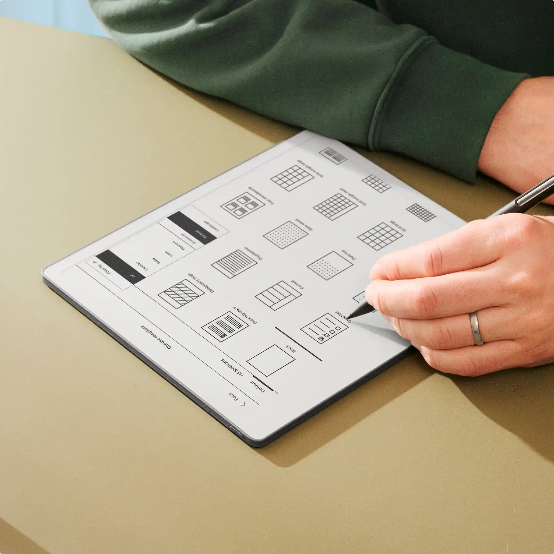 A hand using a marker plus to select a page template from menu.