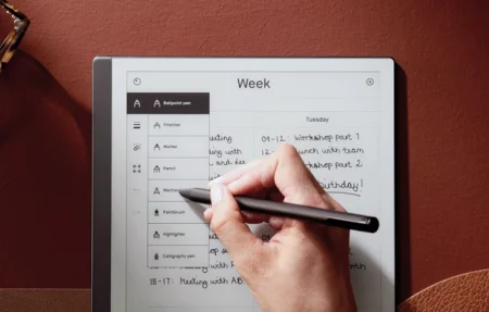 A reMarkable paper tablet displaying the toolbar as a hand selects a Marker type.