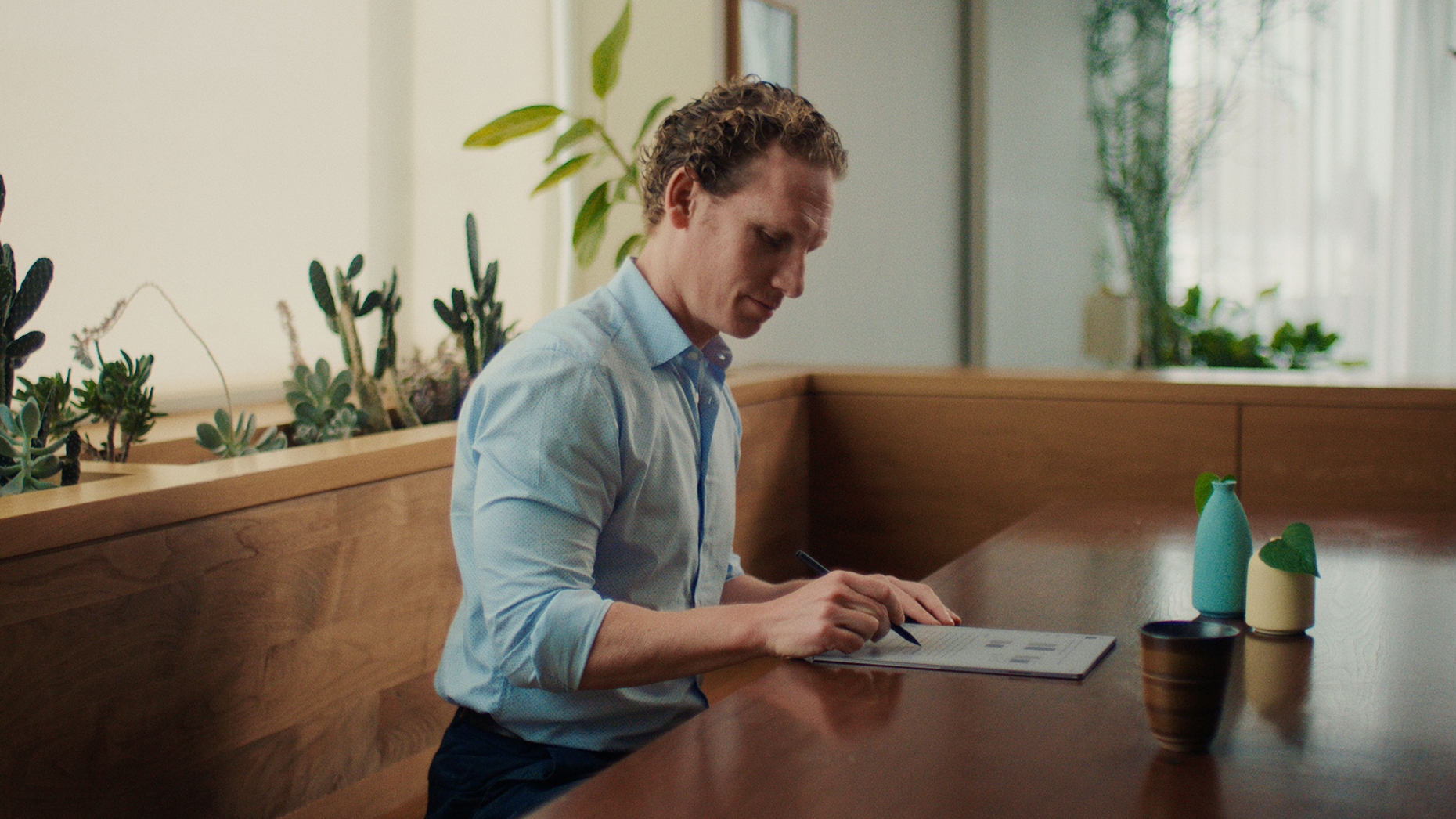 A man writing on a reMarkable paper tablet with the Marker.