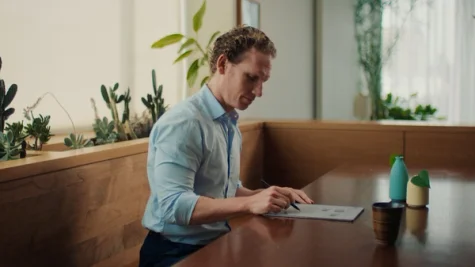 A man reviewing a document at a table with the reMarkable paper tablet.