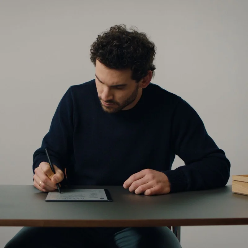 Man writing on reMarkable 2