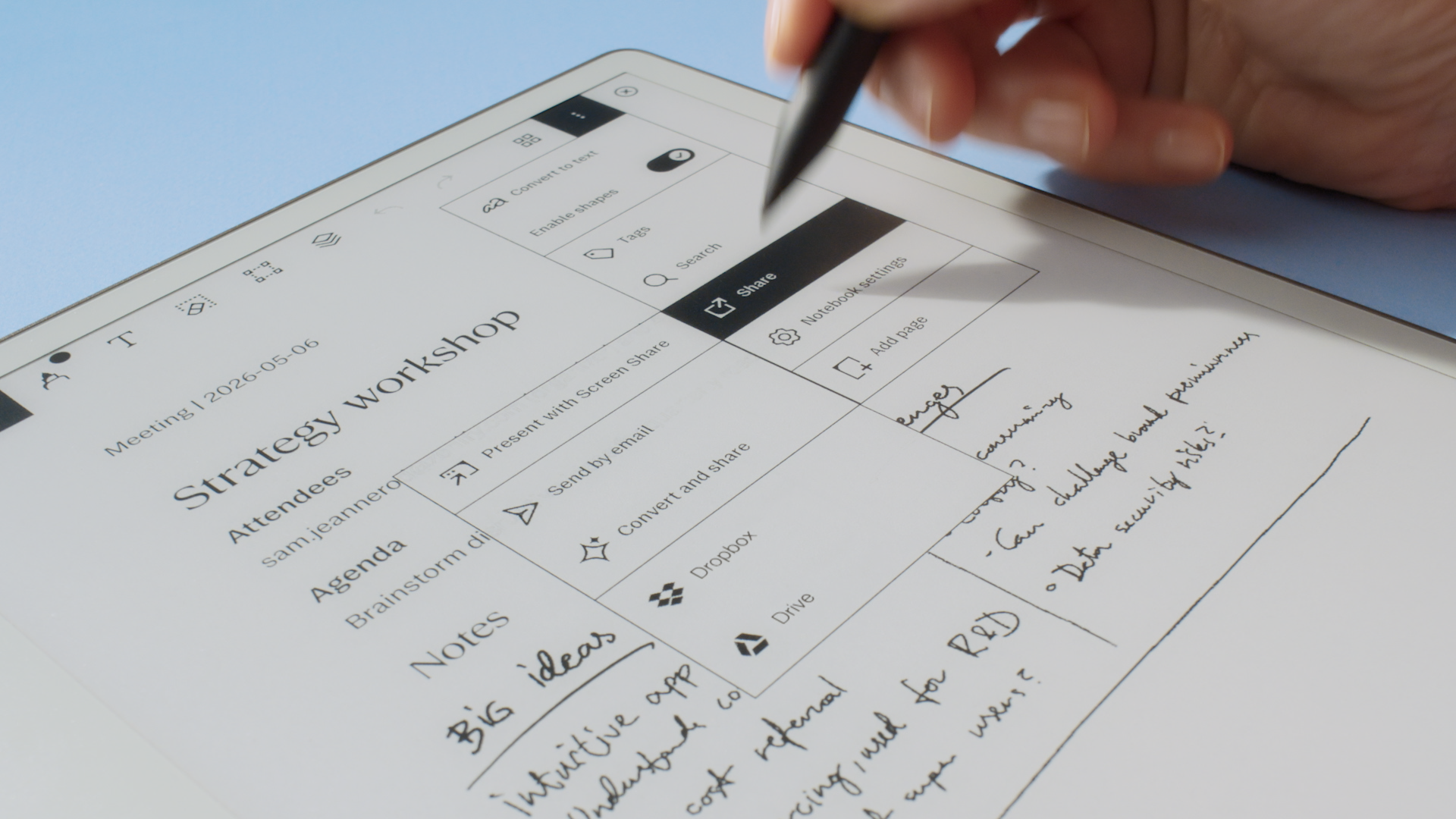 A person pressing the "Share" button on a reMarkable Paper Pure tablet with the Marker plus.