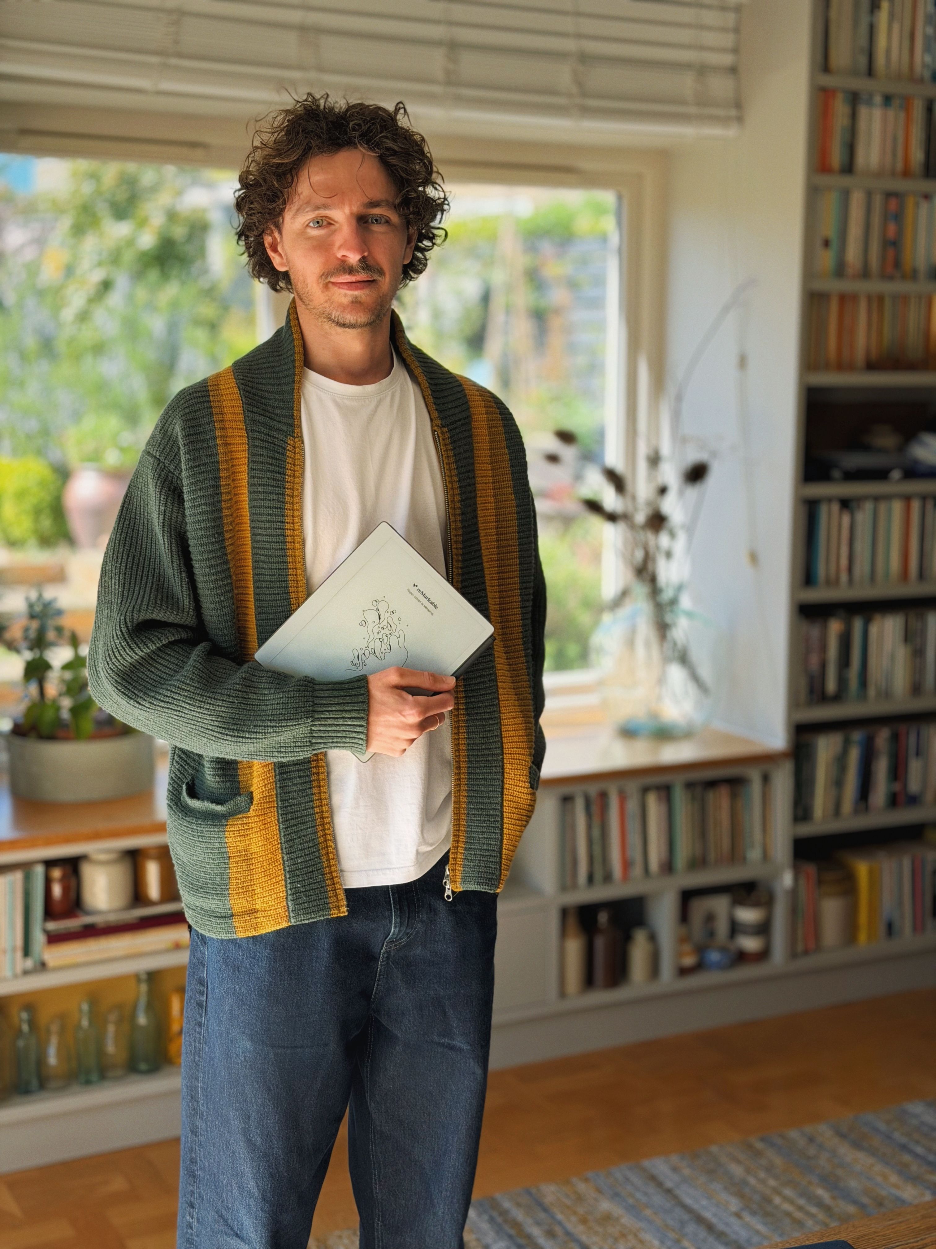  Jack Ogden standing while holding his reMarkable Paper Pure tablet.