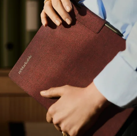 reMarkable Paper Pro tablet with burgundy fabric Book Folio case in hand.