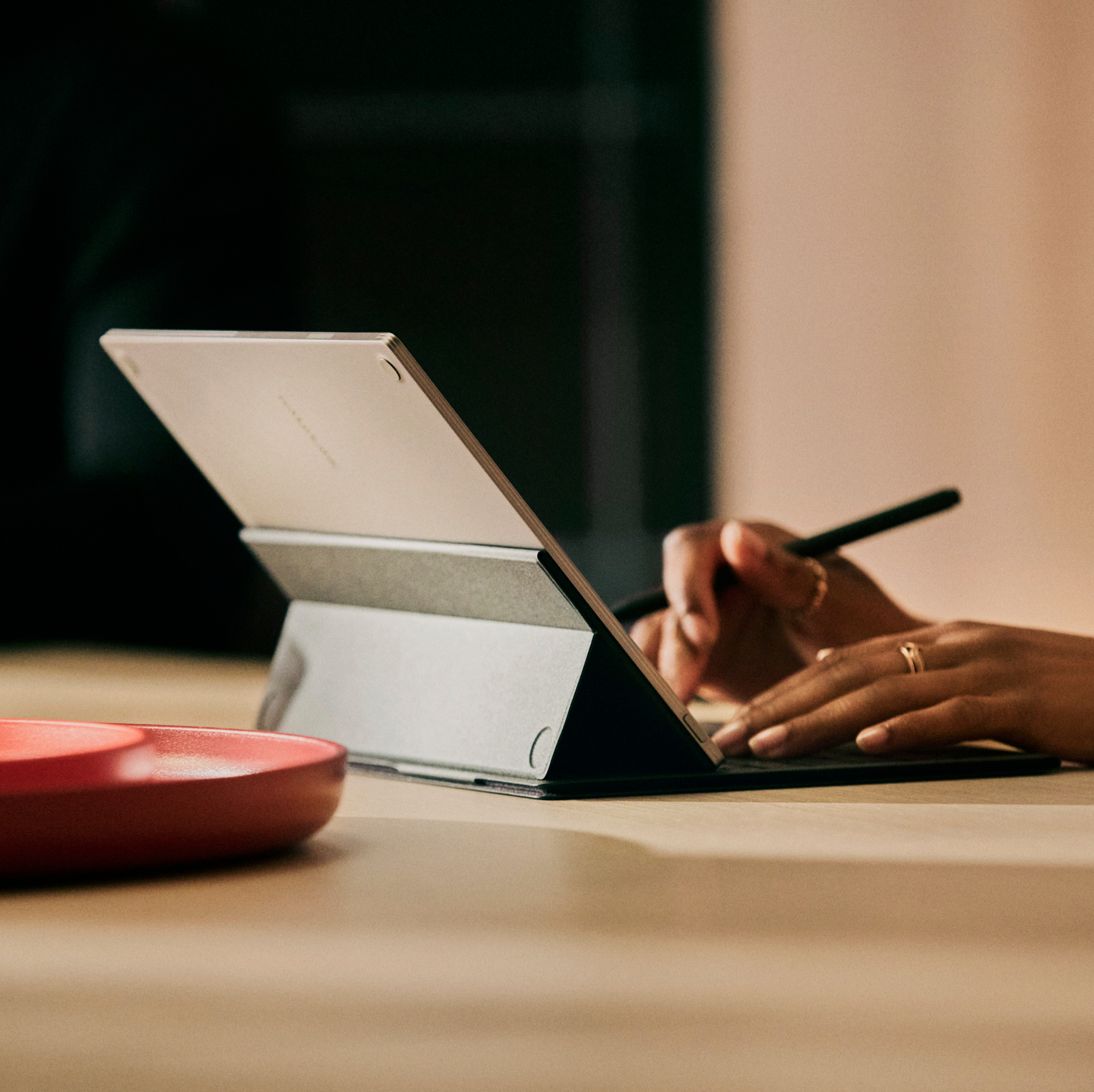 Hands writing on a Type Folio, while holding a Marker Plus