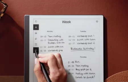 A reMarkable paper tablet showing a weekly calendar and a person tapping the undo button with the Marker.