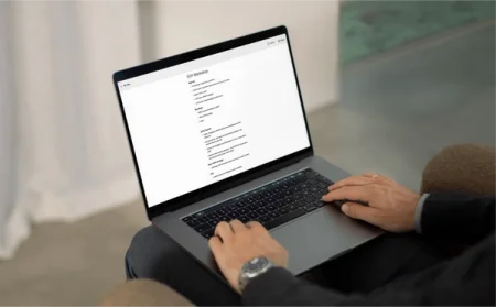 A man sitting in a chair editing notes with the reMarkable desktop app.