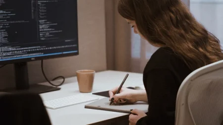 A reMarkable paper tablet, and Filippa writing on the device with the Marker.