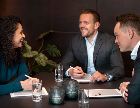 Three persons in a business meeting, all with a reMarkable to take notes.