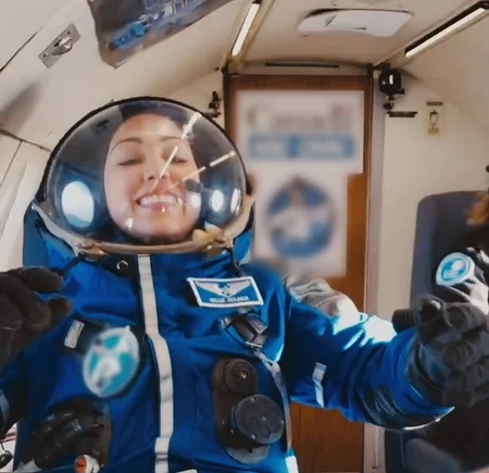 An astronaut in blue space suit and helmet.
