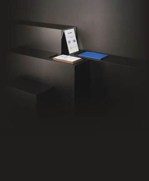 All reMarkable paper tablets, reMarkable 2, reMarkable Paper Pro and reMarkable Paper Pro Move resting on layered shelves.