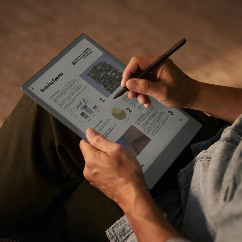 Man sitting with device in dim light