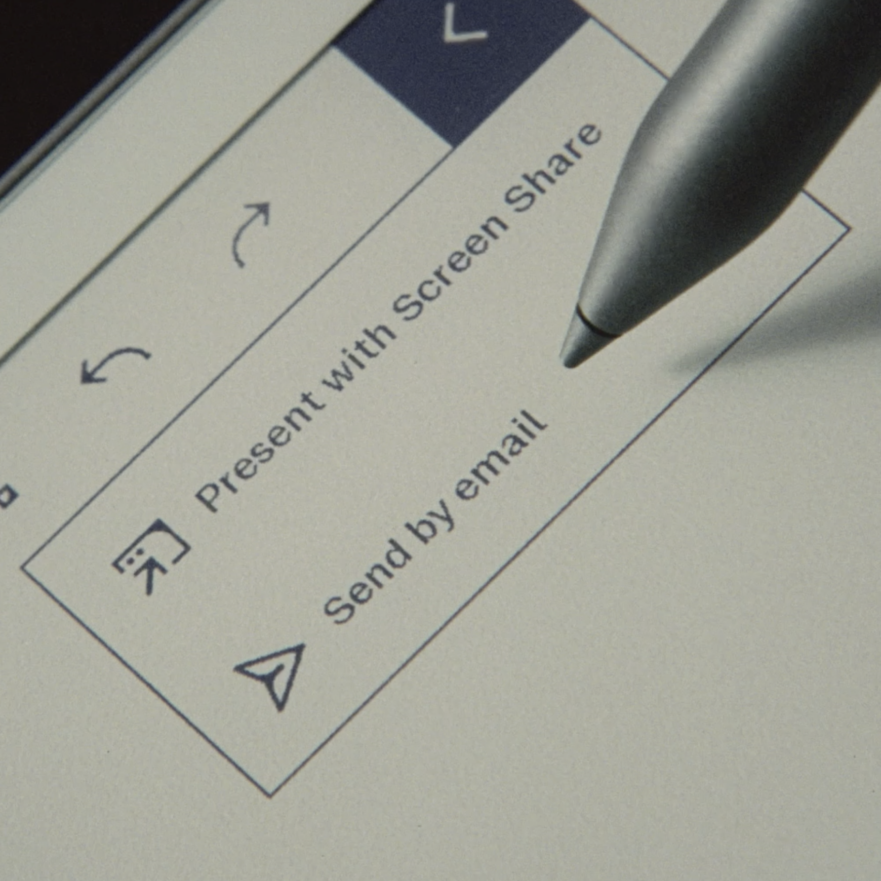 A student selecting the digital features of the reMarkable Paper Pro by sending a document by email.