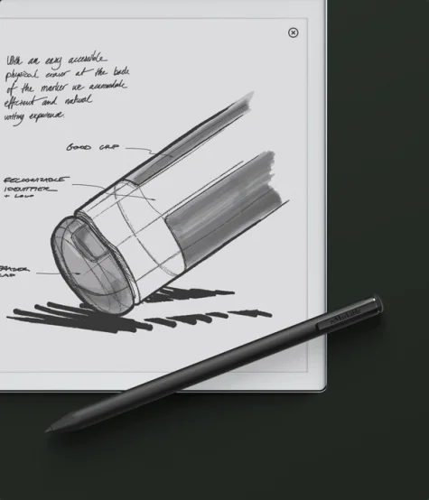 reMarkable 2 tablet displaying sketches and handwritten notes, with a Marker  Plus placed on the dark surface.