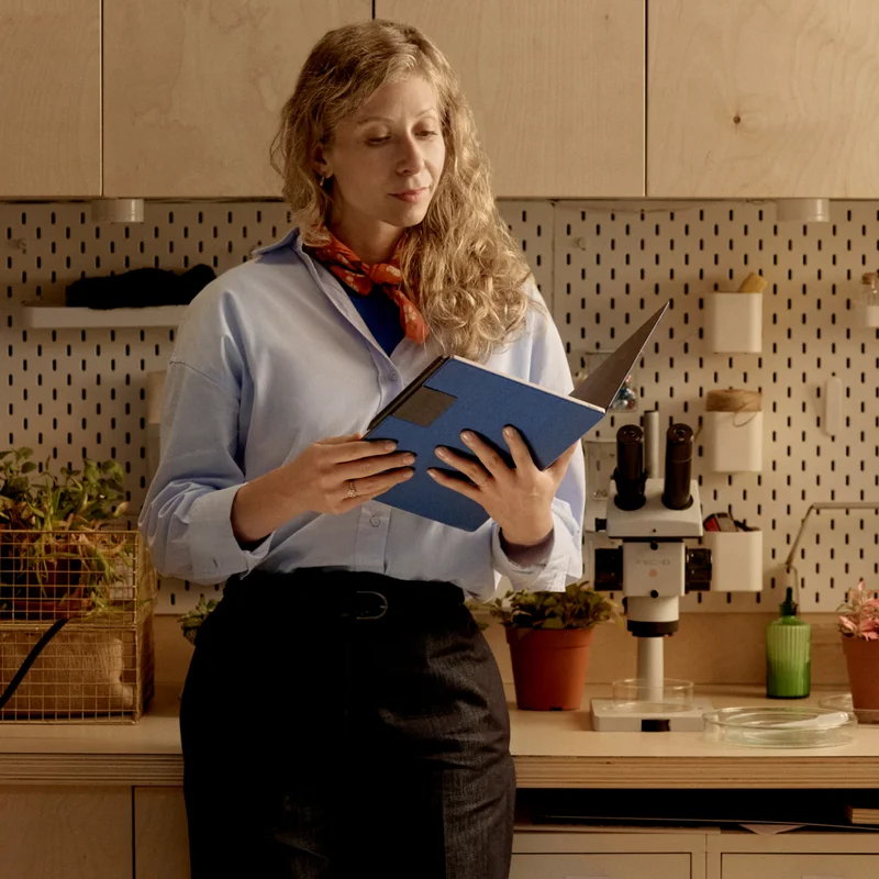 Researcher reads notes on reMarkable Paper Pro next to a microscope.