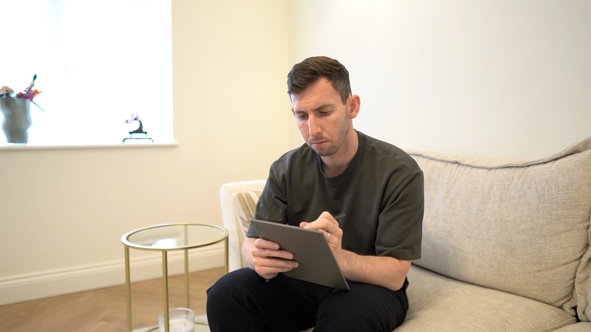 Gabriel Nussbaum sitting on his couch working on his reMarkable Paper Pure tablet.