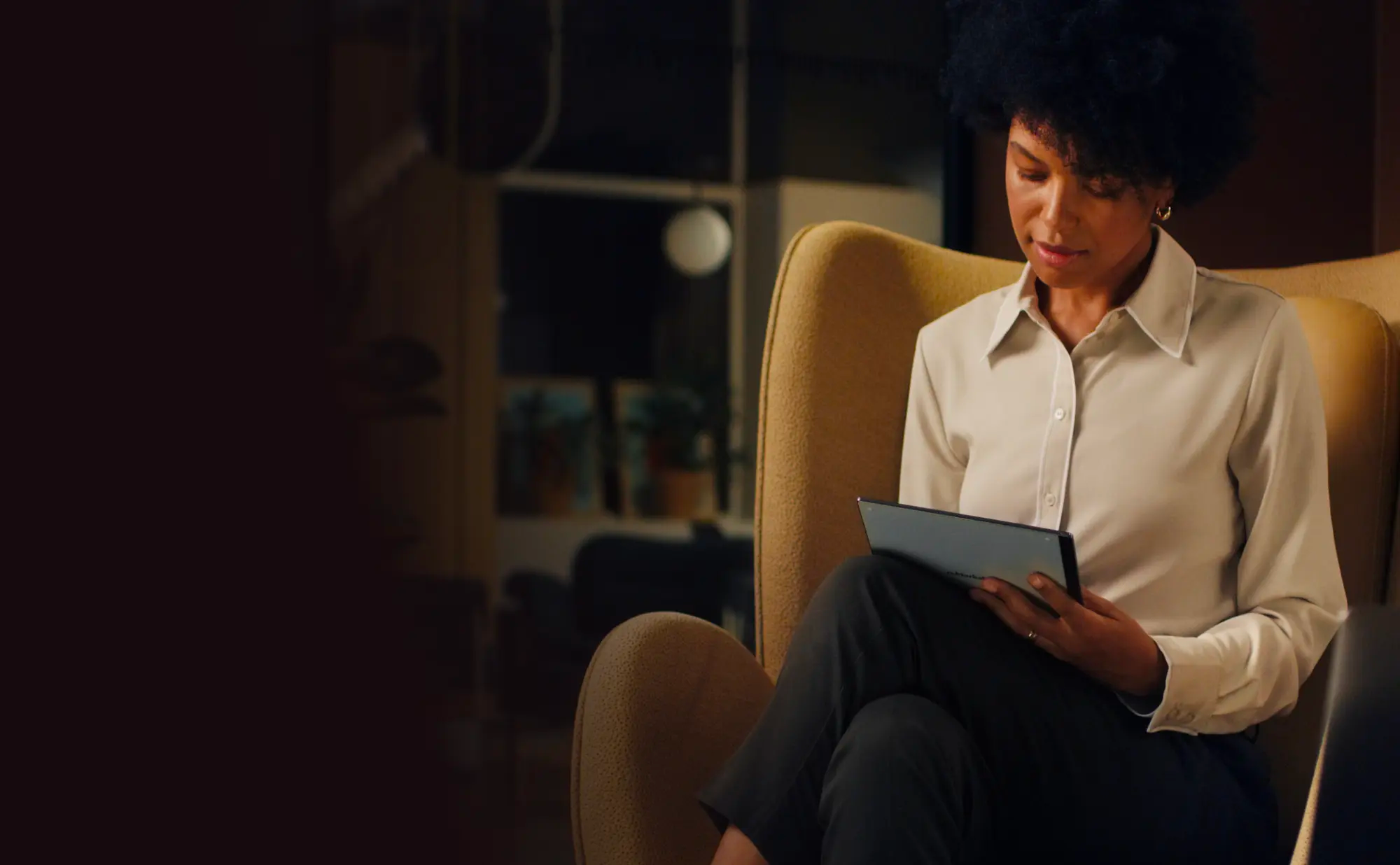 Woman in chair with reMarkable tablet