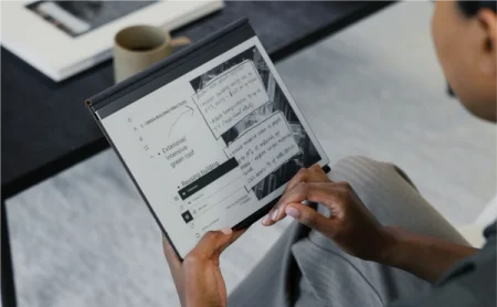 A reMarkable paper tablet showing green building practices with diagrams held in someone's hands.