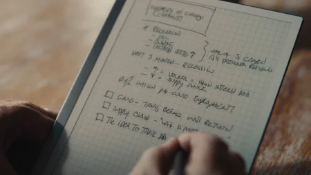 reMarkable paper tablet with notes. A hand is writing on the device with the Marker.