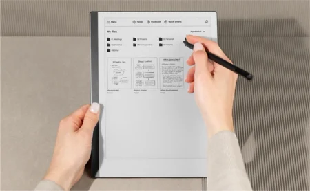 A reMarkable paper tablet showing files, as a hand navigates with the Marker.