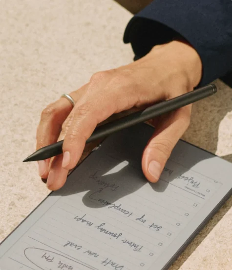 Hand writing notes on a reMarkable Paper Pro Move tablet with the Marker.