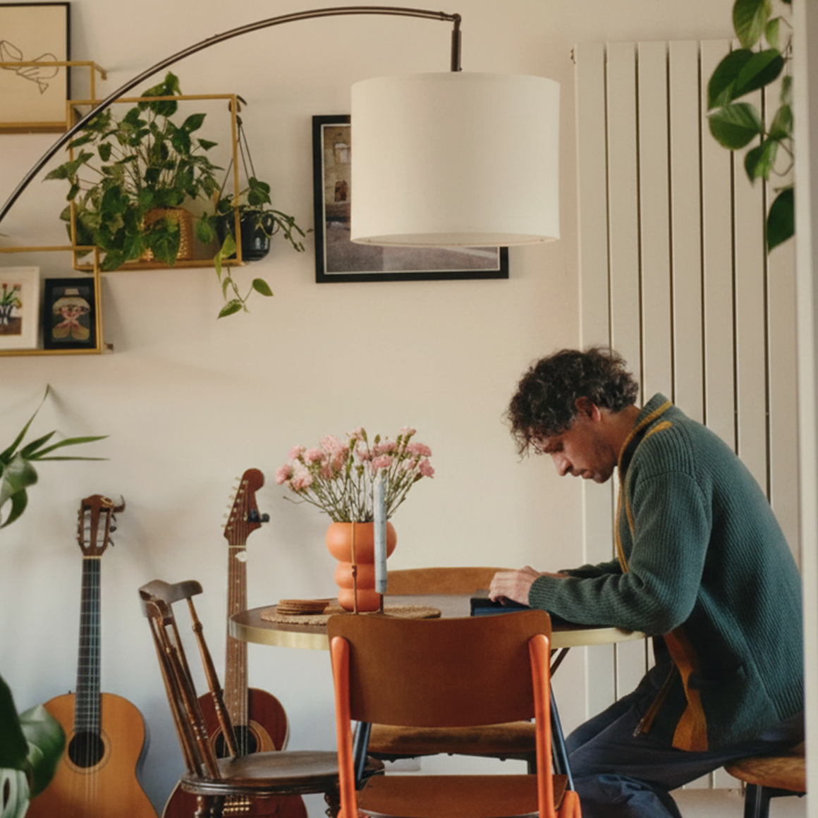 Jake Ogden sitting down at a table to work focused on his reMarkable Paper Pure. 